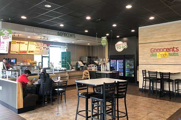 tables and chairs inside a Goodcents location