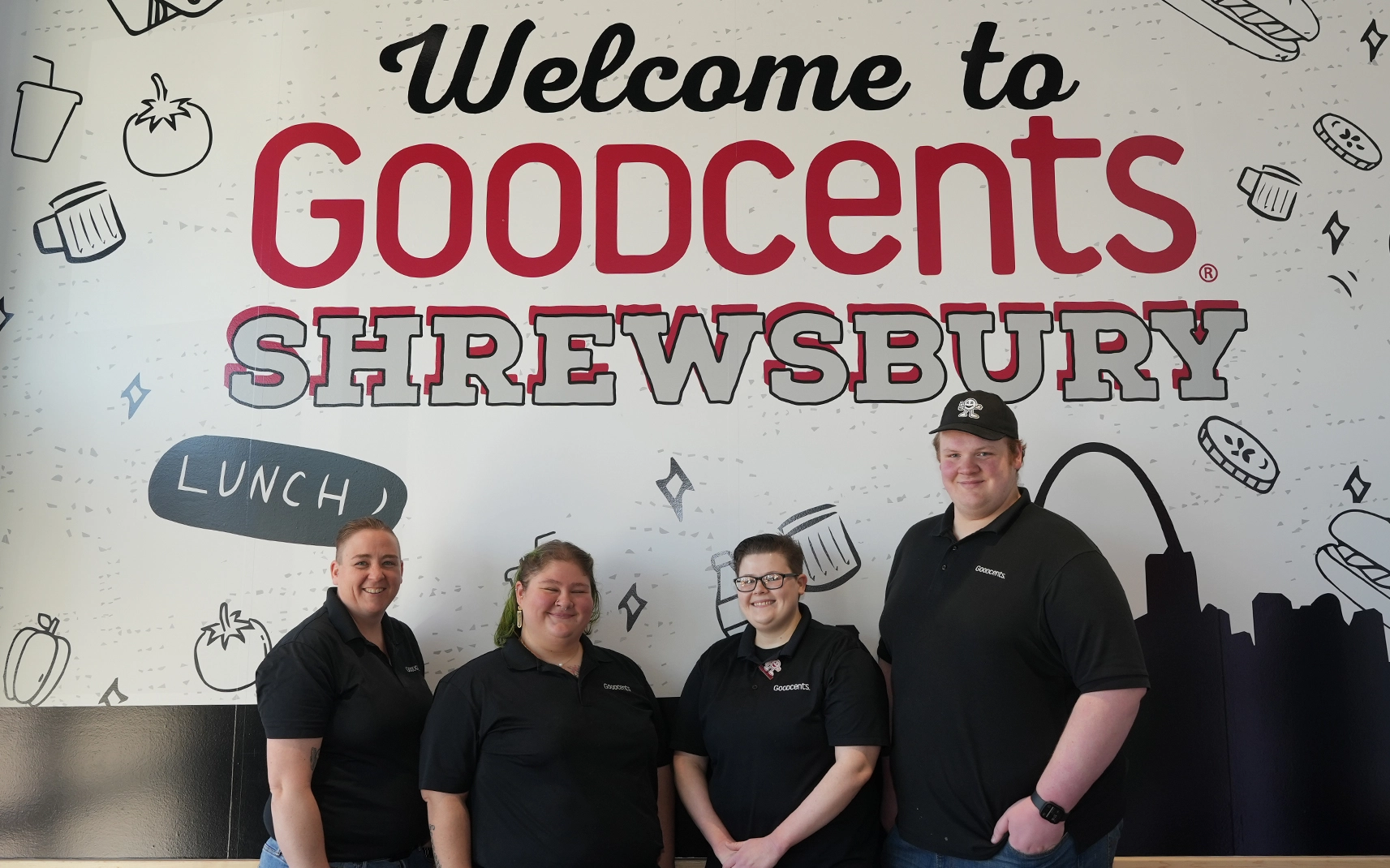 people standing in front of goodcents sign