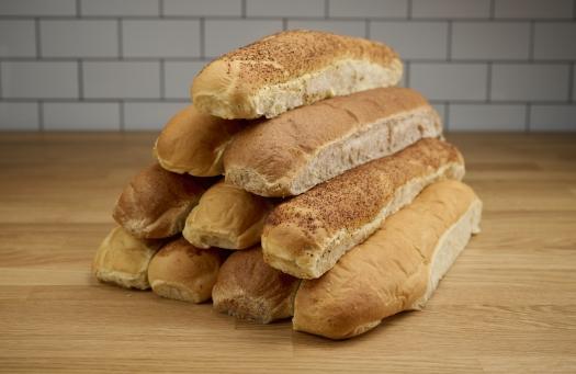 Pyramid of 10 freshly baked Goodcents bread loaves