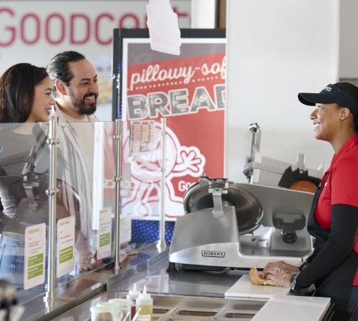 A couple ordering at the counter of a Goodcents